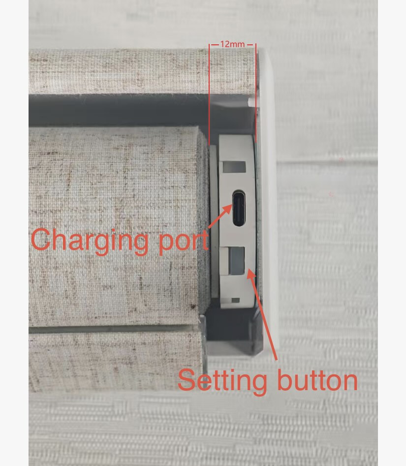 Close-up of the motor side of a motorized roller shade, showcasing VIDEMA's improved craftsmanship that narrows the structural gap to just 12mm while housing the charging port.